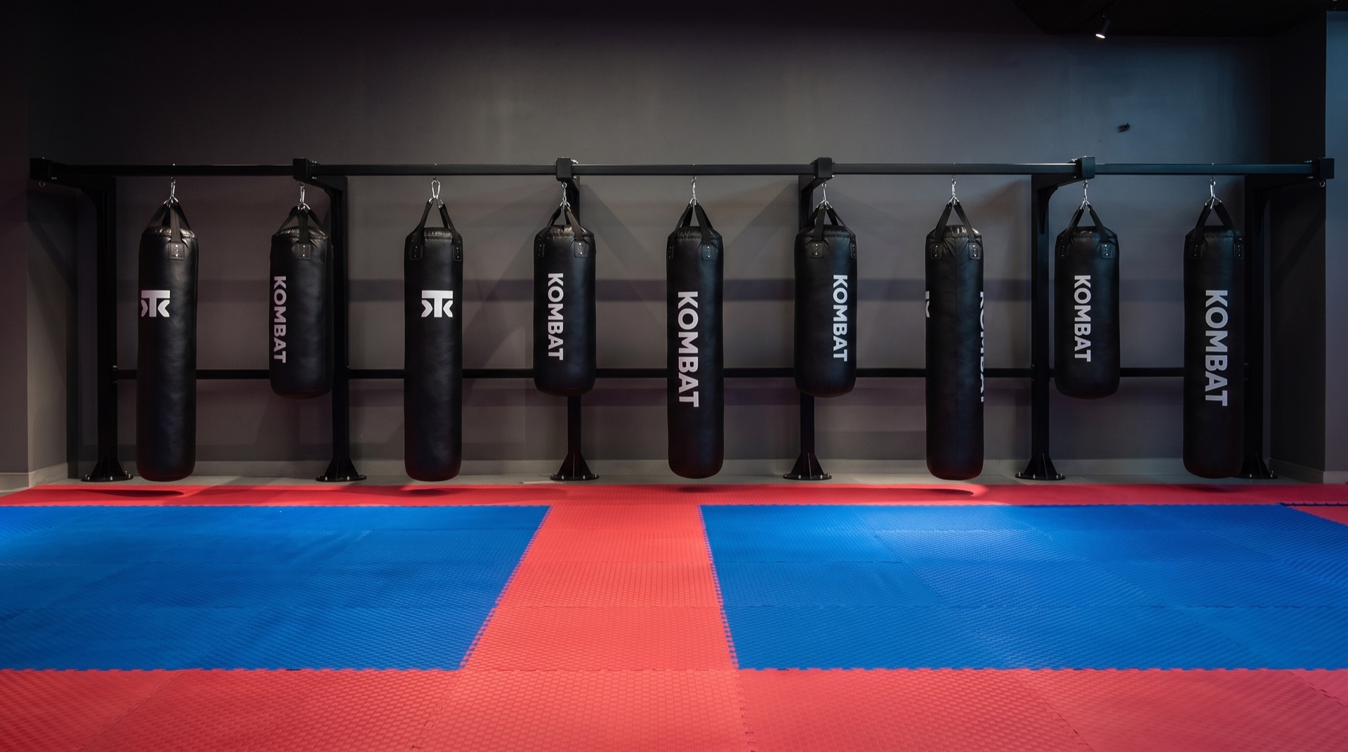 The bag wall and mats inside Kombat Academy
