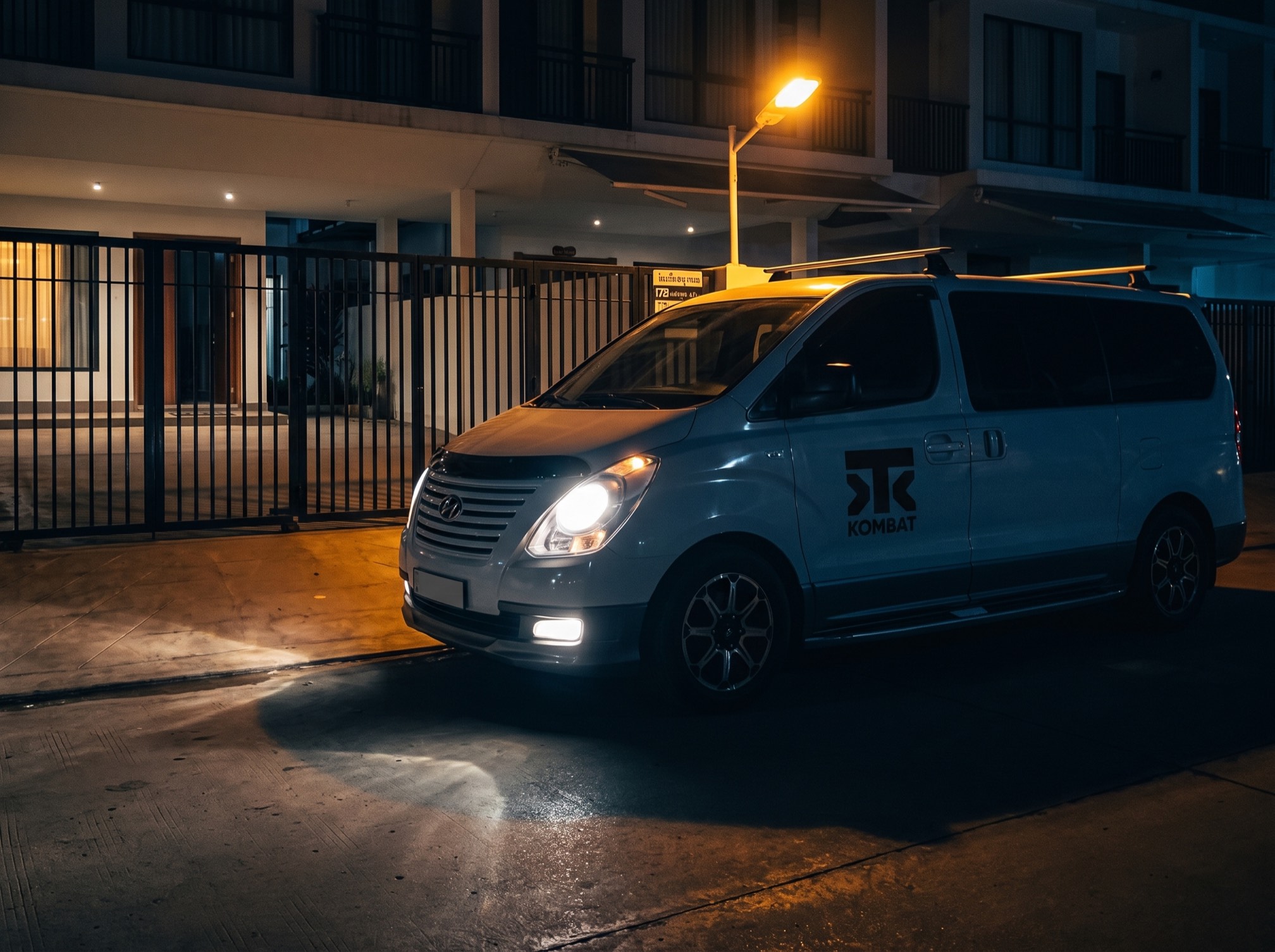 The house van pulling up at the gate at night