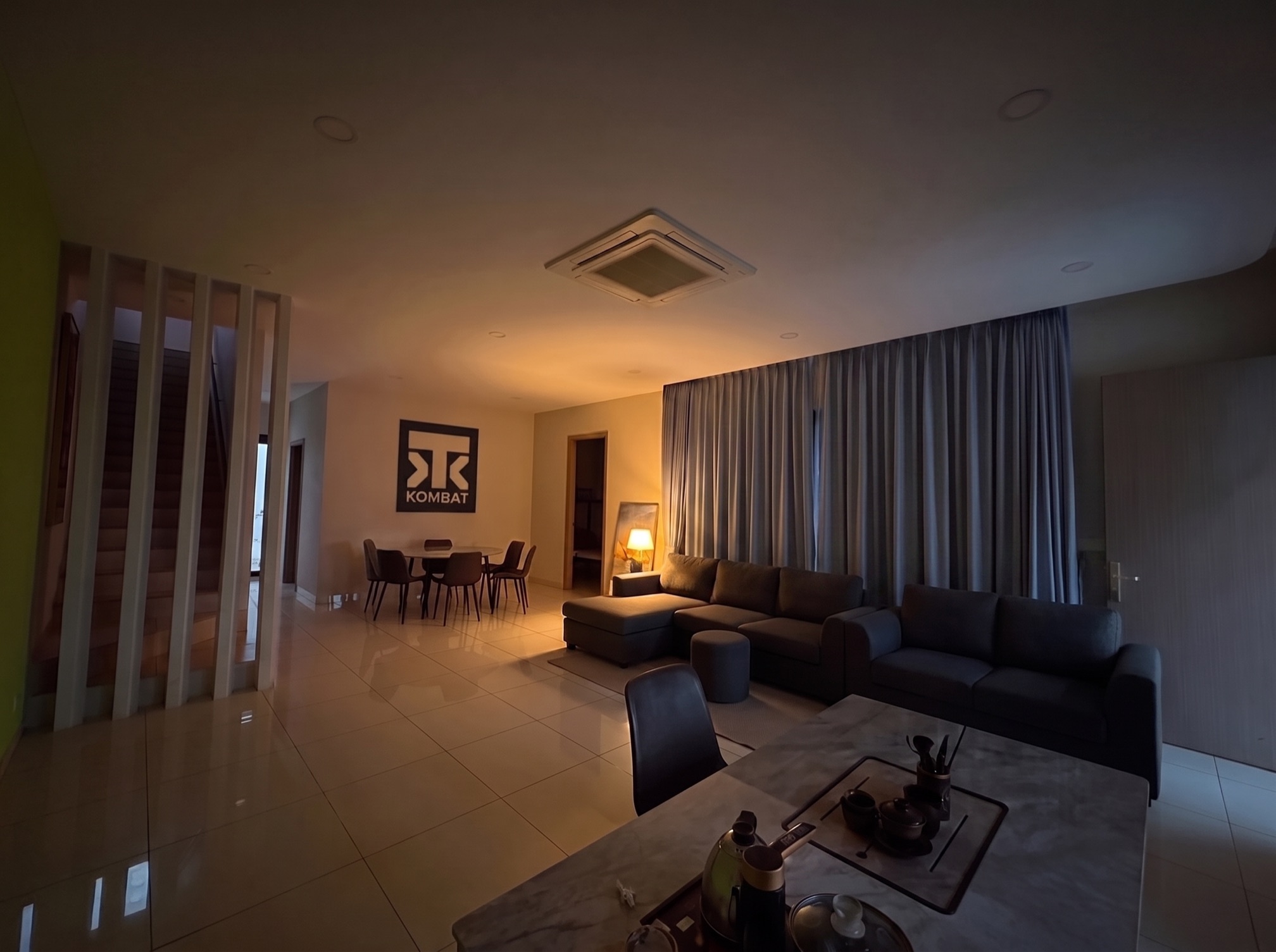 The living area, curtains drawn and lights low